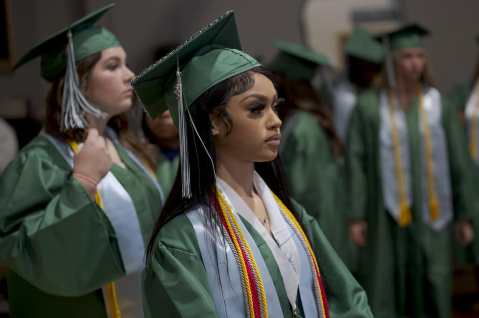 Salutatorian Alasia Baker, 17, foreground, stands next to fellow graduates, including Khyli Barbee, 15, left, before a graduation ceremony for Springfield Preparatory School at Victory in Christ church in Holden, La., Saturday, Aug. 5, 2023. Nearly 9,000 private schools in Louisiana don’t need state approval to grant degrees. Non-approved schools make up a small percentage of the state total. But the students in Louisiana’s off-the-grid school system are a rapidly growing example of the national fallout from COVID-19 — families disengaging from traditional education. (AP Photo/Matthew Hinton)