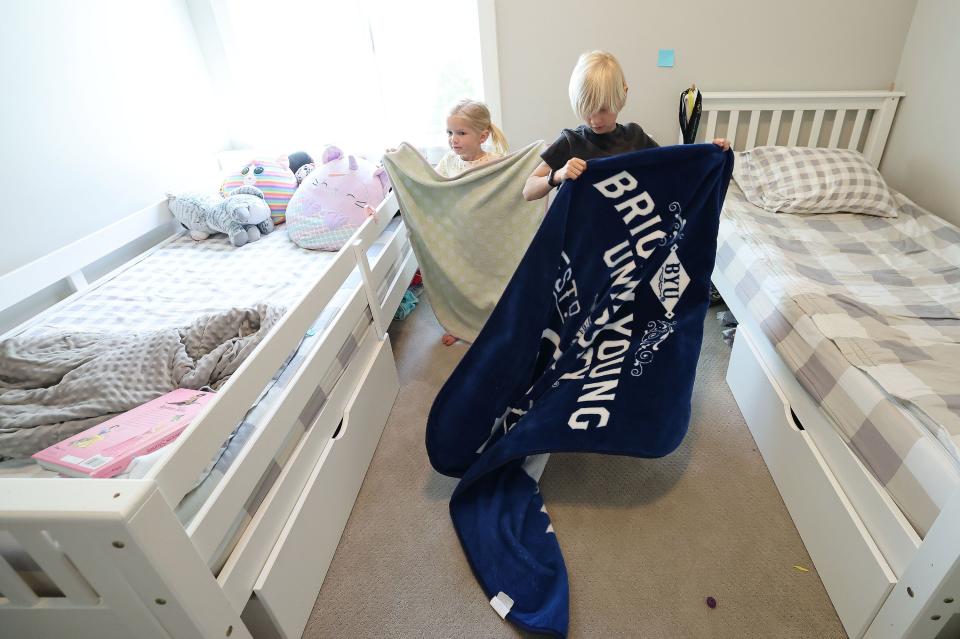 Porter and Ruby Evanson make their beds at home in Lehi on Thursday, May 18, 2023. | Jeffrey D. Allred, Deseret News