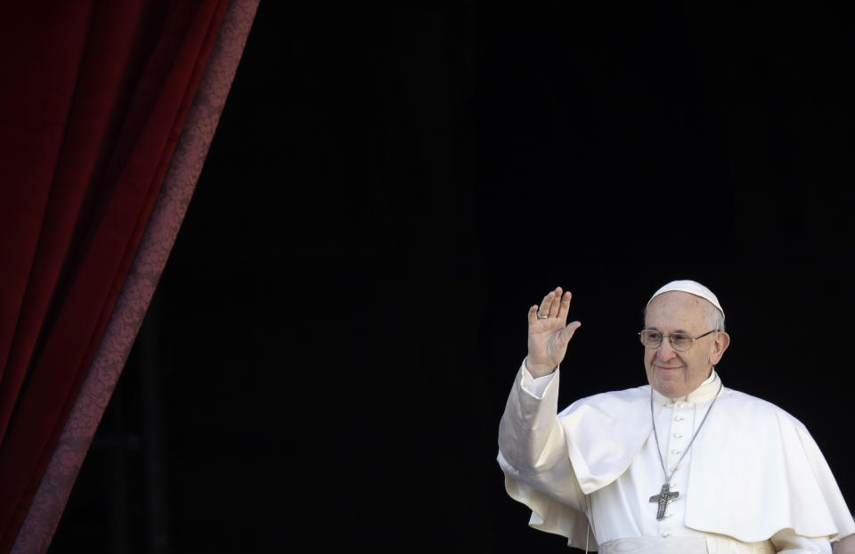 Pope Francis waves as he arrives to deliver the Urbi et Orbi (Latin for 'to the city and to the world' ) Christmas' day blessing from the main balcony of St. Peter's Basilica at the Vatican, Tuesday, Dec. 25, 2018. (AP Photo/Alessandra Tarantino)