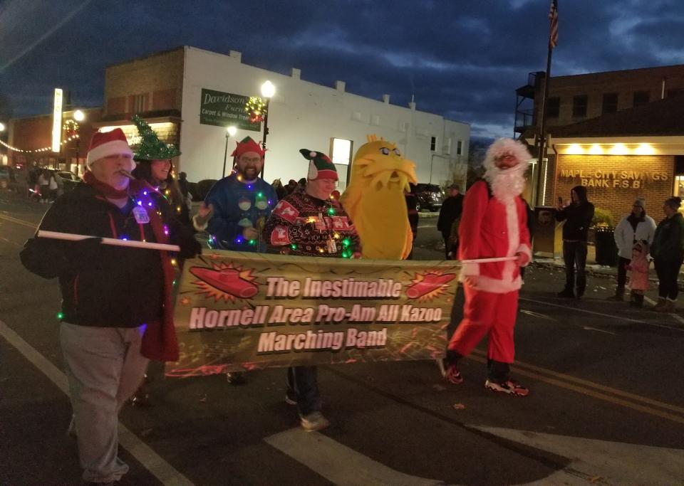 Santa and the Lorax fill out the ranks of the ambitiously named kazoo band at the Hornell for the Holidays parade.