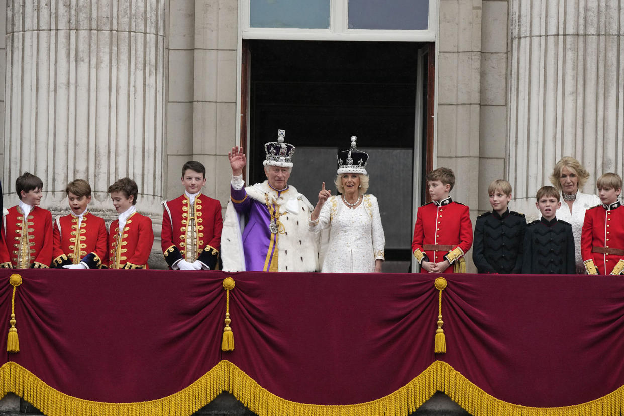 Britain's King Charles III and Queen Camilla greet the crowds from the balcony of Buckingham Palace (Frank Augstein / AP)