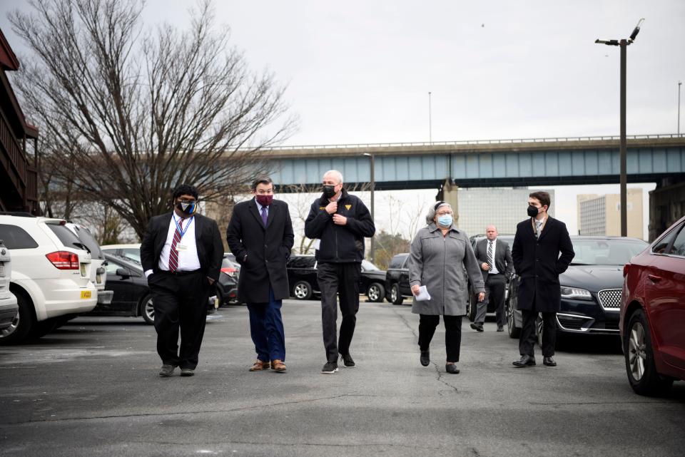 (Center) Governor Phil Murphy walks with the Route 3 bridge in Secaucus behind him before the start of a press conference on Tuesday, January 25, 2022, announcing planned construction on the bridge.