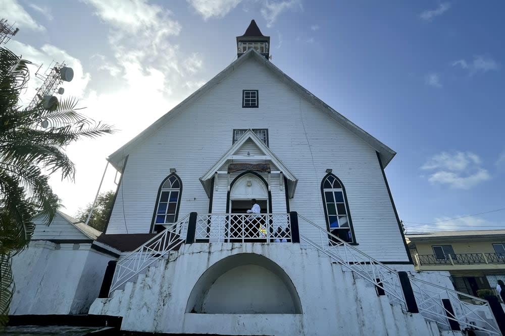 A man stands at the entrance of First Baptist Church on Colombia’s San Andres Island on Sunday, Aug. 21, 2022. The church is a symbol of emancipation and a source of pride for the Raizals, the English-speaking, mostly Protestant inhabitants of San Andres and smaller islands that form an archipelago in the western Caribbean. (AP Photo/Luis Andres Henao)