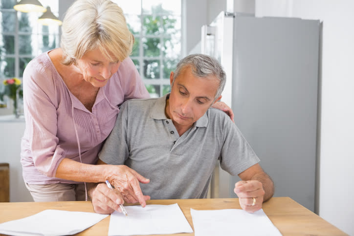 A senior couple reviewing paperwork for RMDs.