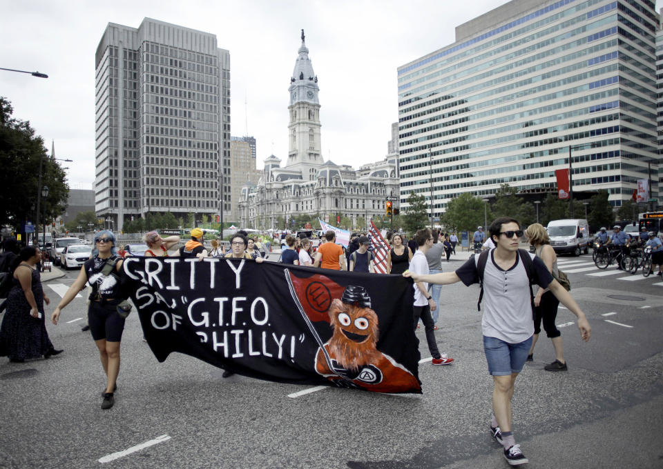 Demonstrators march through the Center City holding a banner with an image of Philadelphia Flyers’ new mascot Gritty before a speech by President Donald Trump at the National Electrical Contractors Convention, Tuesday, Oct. 2, 2018, in Philadelphia. Philadelphians are using the city’s latest sports mascot to protest a visit by Trump. (AP Photo/Matt Slocum)