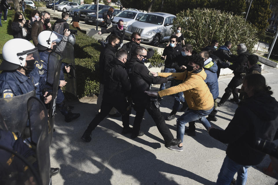 Police clash with protesters at the University of Thessaloniki in northern Greece, on Monday, Feb. 22, 2021. Police clashed with protesters and detained more than 30 people in Greece's second-largest city Monday during a demonstration against a new campus security law. (AP Photo/Giannis Papanikos)