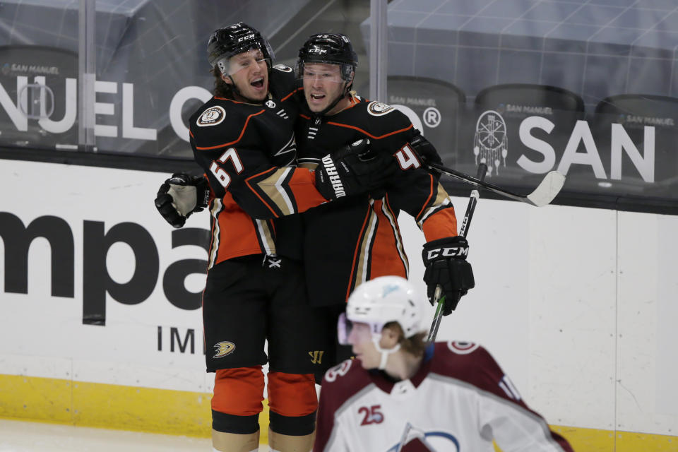 Anaheim Ducks center Rickard Rakell, left, celebrates scoring a goal with defenseman Andy Welinski during the second period of an NHL hockey game against the Colorado Avalanche in Anaheim, Calif., Sunday, Jan. 24, 2021. (AP Photo/Alex Gallardo)