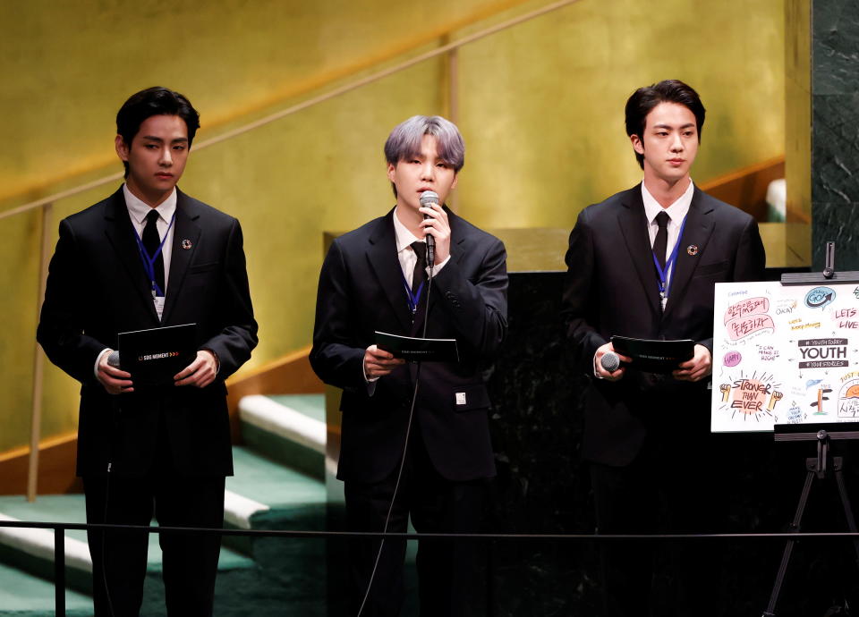 (L to R) V, Suga and Jin of South Korean boy band BTS speak at the SDG Moment event as part of the UN General Assembly 76th session General Debate in UN General Assembly Hall at the United Nations Headquarters, in New York, U.S., September 20, 2021. John Angelillo/Pool via REUTERS