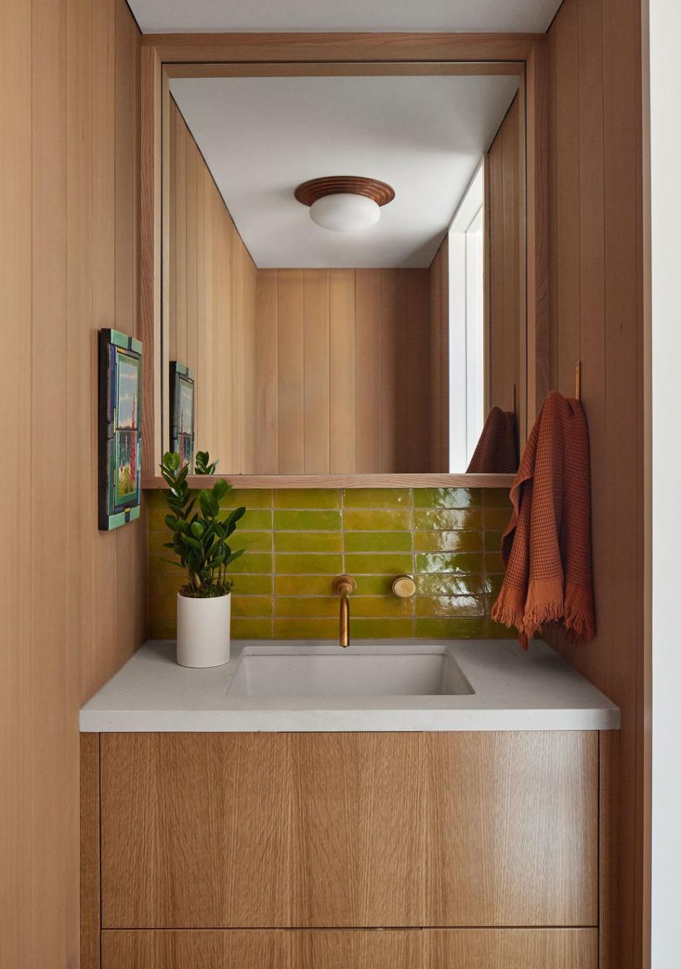 powder room with wood walls and vanity