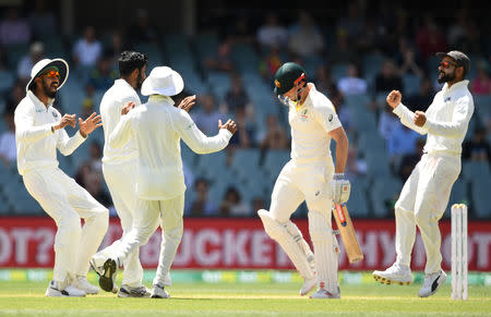 India's players celebrate the dismissal of Australia's Shaun Marsh (2nd R) on day five of the first test match between Australia and India at the Adelaide Oval in Adelaide, Australia, December 10, 2018. AAP/Dave Hunt/via REUTERS