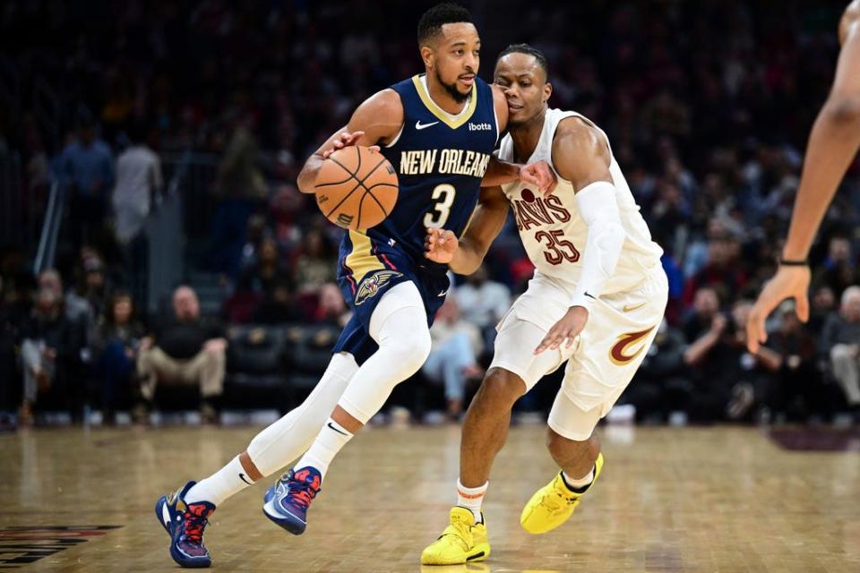 New Orleans Pelicans guard CJ McCollum (3) drives against Cleveland Cavaliers forward Isaac Okoro (35) in the second half Thursday in Cleveland.