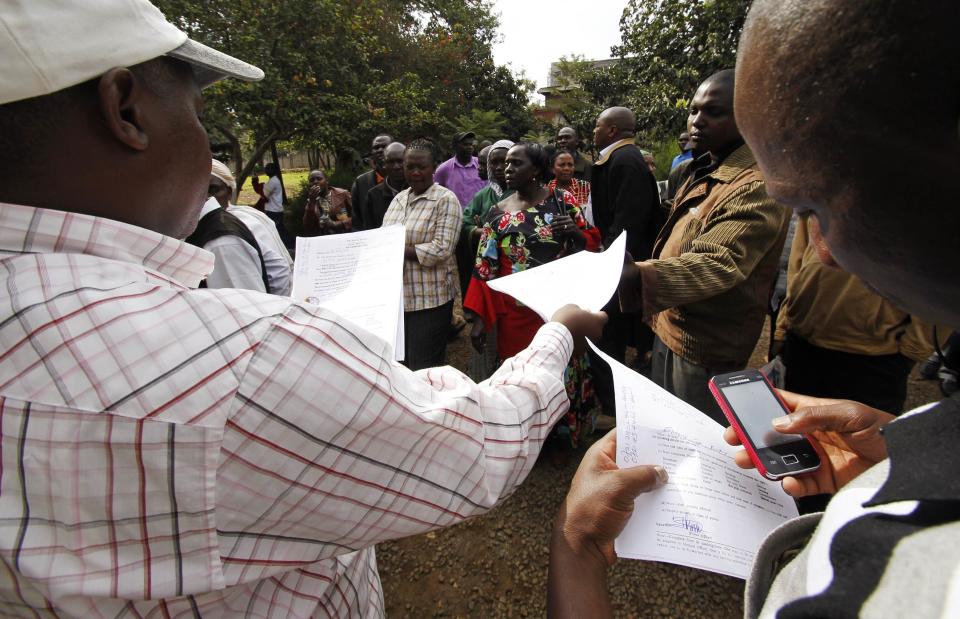 Bereaved people process funeral documents at the city mortuary for their relatives killed in the Westgate shopping mall attack, in Nairobi