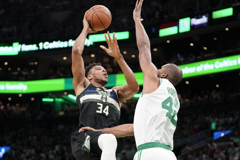 Milwaukee Bucks forward Giannis Antetokounmpo (34) shoots at the basket as Boston Celtics center Al Horford (42) defends during the first half of Game 7 of an NBA basketball Eastern Conference semifinals playoff series, Sunday, May 15, 2022, in Boston. (AP Photo/Steven Senne)