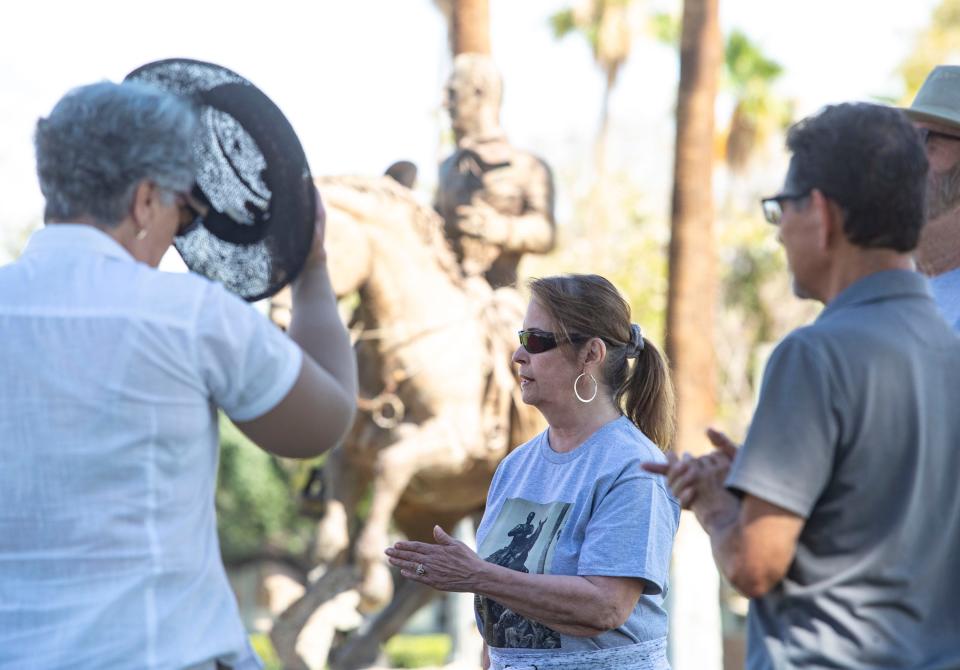 Irene Gillespie of Palm Springs speaks with other Friends of Frank Bogert organization members and supporters in front of his statue at City Hall in Palm Springs, Calif., Friday, June 3, 2022.
