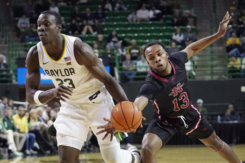 Baylor forward Jonathan Tchamwa Tchatchoua (23) dribbles against Nicholls State guard Byron Ireland (13) during the first half of an NCAA college basketball game in Waco, Texas, Tuesday, Nov. 28, 2023. (AP Photo/LM Otero)