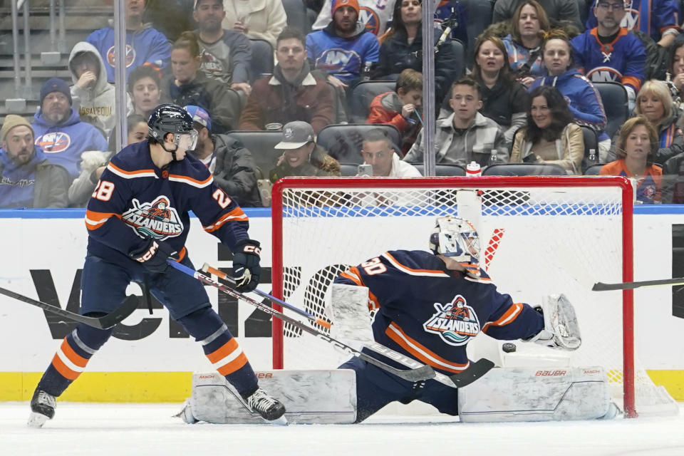 New York Islanders goaltender Ilya Sorokin (30) and Alexander Romanov watch the puck after Carolina Hurricanes center Paul Stastny scored a goal during the second period of an NHL hockey game, Saturday, Dec. 10, 2022, in Elmont, N.Y. (AP Photo/Mary Altaffer)