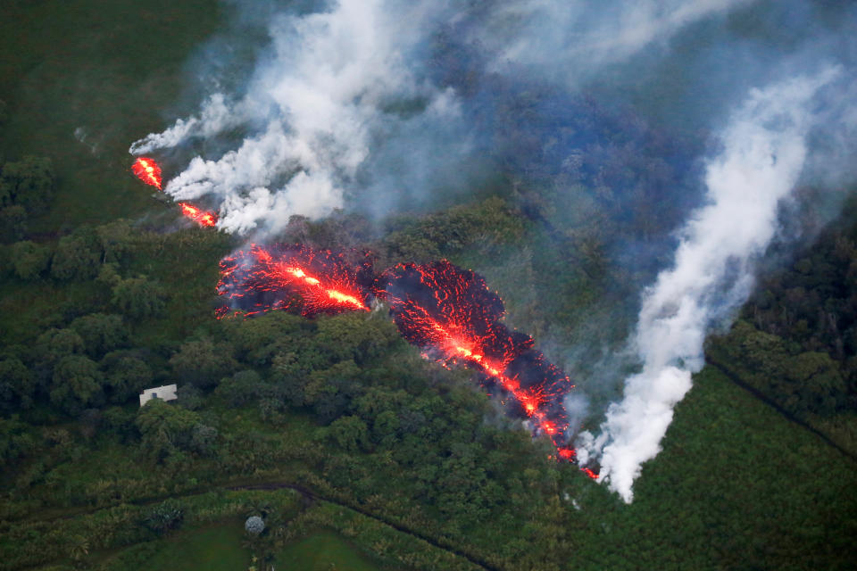 <p>Lava erupts from a fissure east of the Leilani Estates subdivision during ongoing eruptions of the Kilauea Volcano in Hawaii, on May 13, 2018. (Photo: Terray Sylvester/Reuters) </p>