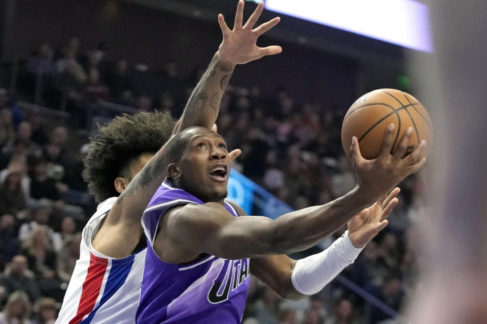 FILE - Utah Jazz guard Kris Dunn (11) goes to the basket as Detroit Pistons forward Isaiah Livers (12) defends during the first half of an NBA basketball game Wednesday, Jan. 3, 2024, in Salt Lake City. No NBA team has enjoyed greater success in January so far than Utah. One factor quietly keying the surge has been the steady play of point guard Kris Dunn. (AP Photo/Rick Bowmer, File)