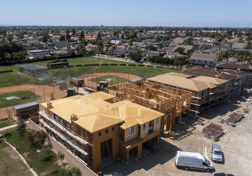 Huntington Beach, CA - August 09: An aerial view of workers constructing new homes at the LeBard Park and Residential Project in Huntington Beach on Monday, Aug. 9, 2021. (Allen J. Schaben / Los Angeles Times)