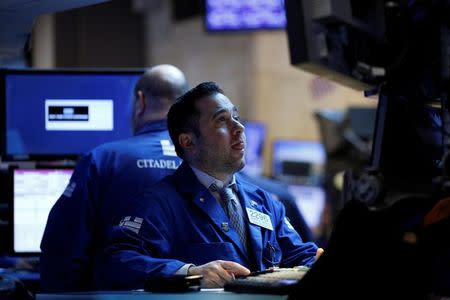 Traders work on the floor of the New York Stock Exchange (NYSE) in New York, U.S., February 22, 2017. REUTERS/Brendan McDermid