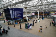 Passengers at Edinburgh Waverley station, as train services continue to be disrupted following the nationwide strike by members of the Rail, Maritime and Transport union in a bitter dispute over pay, jobs and conditions, in Edinburgh, Scotland, Thursday, June 23, 2022. (Andrew Milligan/PA via AP)
