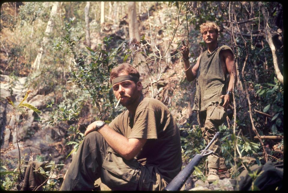 Retired Judge George Paine II, left, in the Vietnam war.