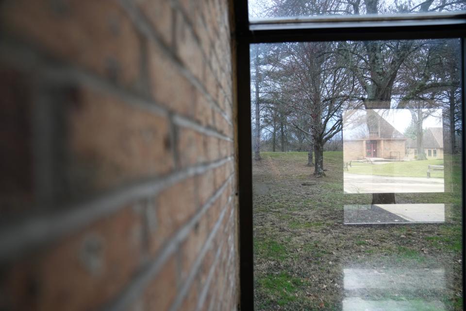 Throughout the entire Hillcrest School campus, windows are a prominent feature, including this walkway between two sections within the school building, Tuesday, March 5, 2024, at Hillcrest School in Springfield Township. The onetime residential program for at-risk youth was closed last year. Hamilton County Juvenile Court wants to re-open the facility, which had been run by a nonprofit and fallen into disrepair.