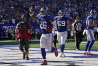 New York Giants running back Saquon Barkley (26) celebrates after scoring a touchdown during the second half of an NFL football game against the Atlanta Falcons, Sunday, Sept. 26, 2021, in East Rutherford, N.J. (AP Photo/Seth Wenig)