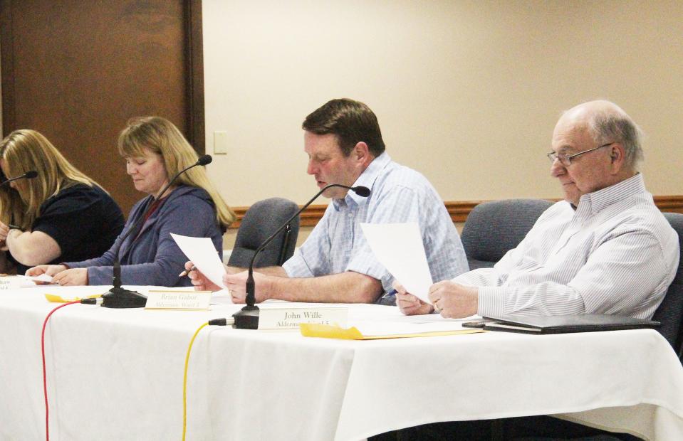Fifth Ward Alderman Brian Gabor, second from right, reads his report on a recently held Infrastructure Committee meeting at Monday's Pontiac City Council meeting. Among the alderpersons listening and reading along are, from left, Maggie Clark, Jayme Bradshaw and John Wille.