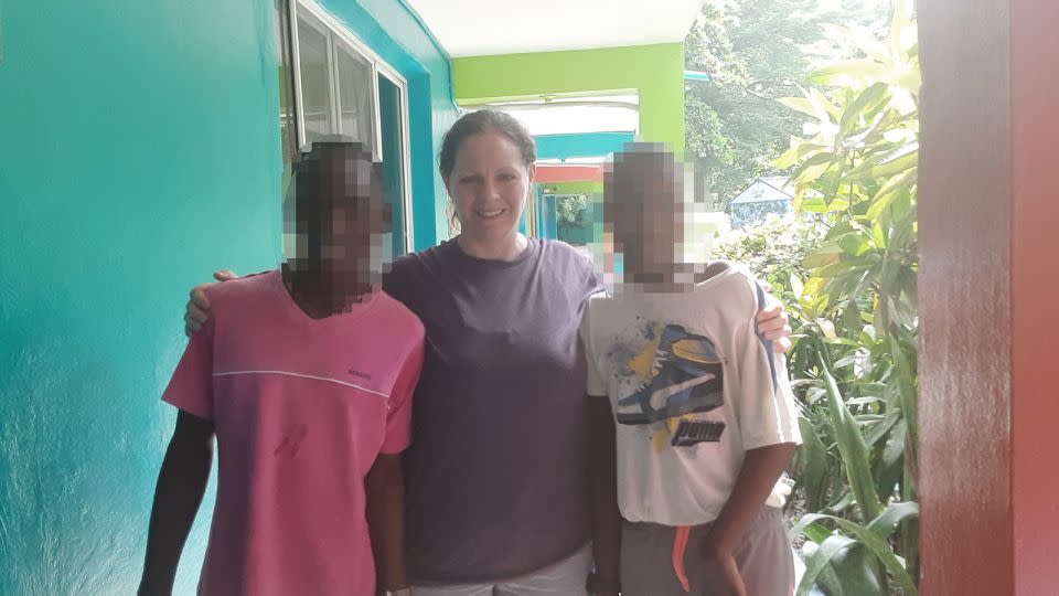 Missy Tennant is seen in an undated photo with the<strong> </strong>two children from Haiti who are now stuck at an orphanage there. CNN blurred the faces of the children to protect their identity. - Courtesy Missy Tennant