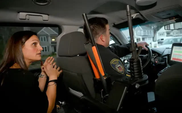 Bonnie Cuccaro, left, of the Advocates Inc., is the day shift co-response clinician for the Framingham Police Department. She is shown riding with Framingham police Sgt. Brian Curtis while speaking with Andrew Lacey (not pictured), a superintendent with the An Garda Siochana, the Irish National Police.