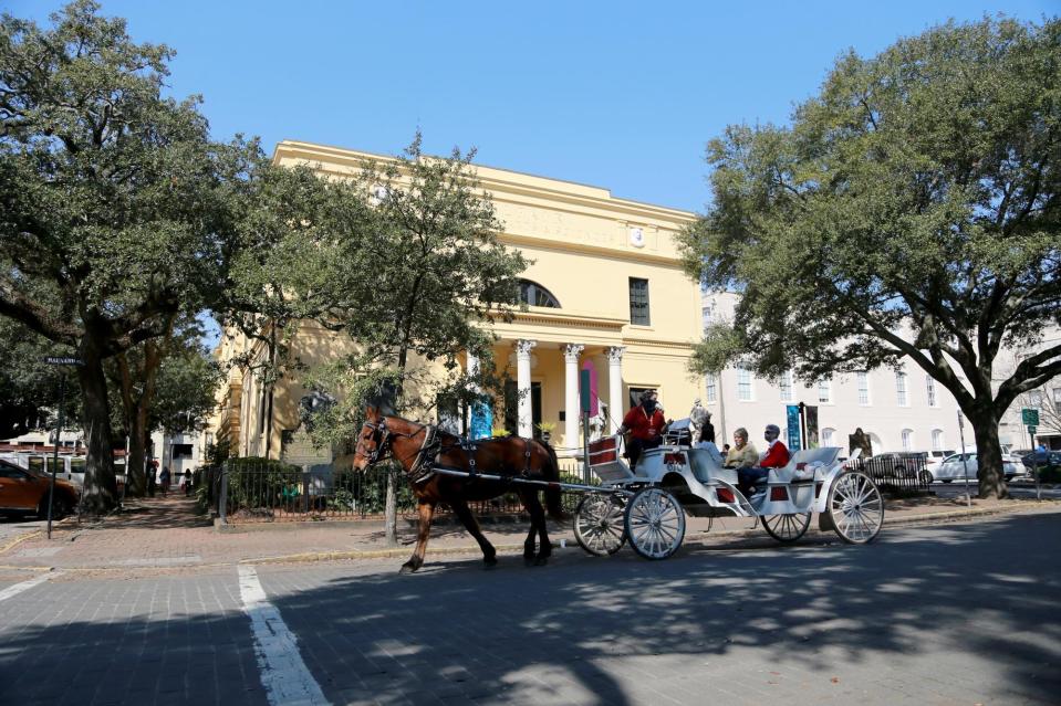 A carriage passes the Telfair Museum during an early after tour through historic downtown Savannah.
