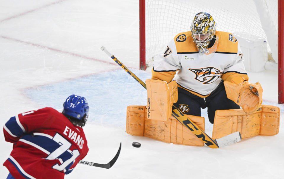 Nashville Predators goaltender Juuse Saros stops Montreal Canadiens' Jake Evans during the second period of an NHL hockey game in Montreal, Sunday, Dec. 10, 2023. (Graham Hughes/The Canadian Press via AP)