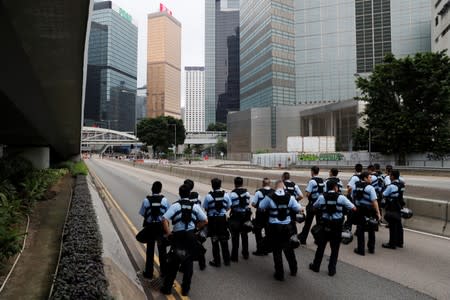 Police gather on a road near the Legislative Council building in Hong Kong, China
