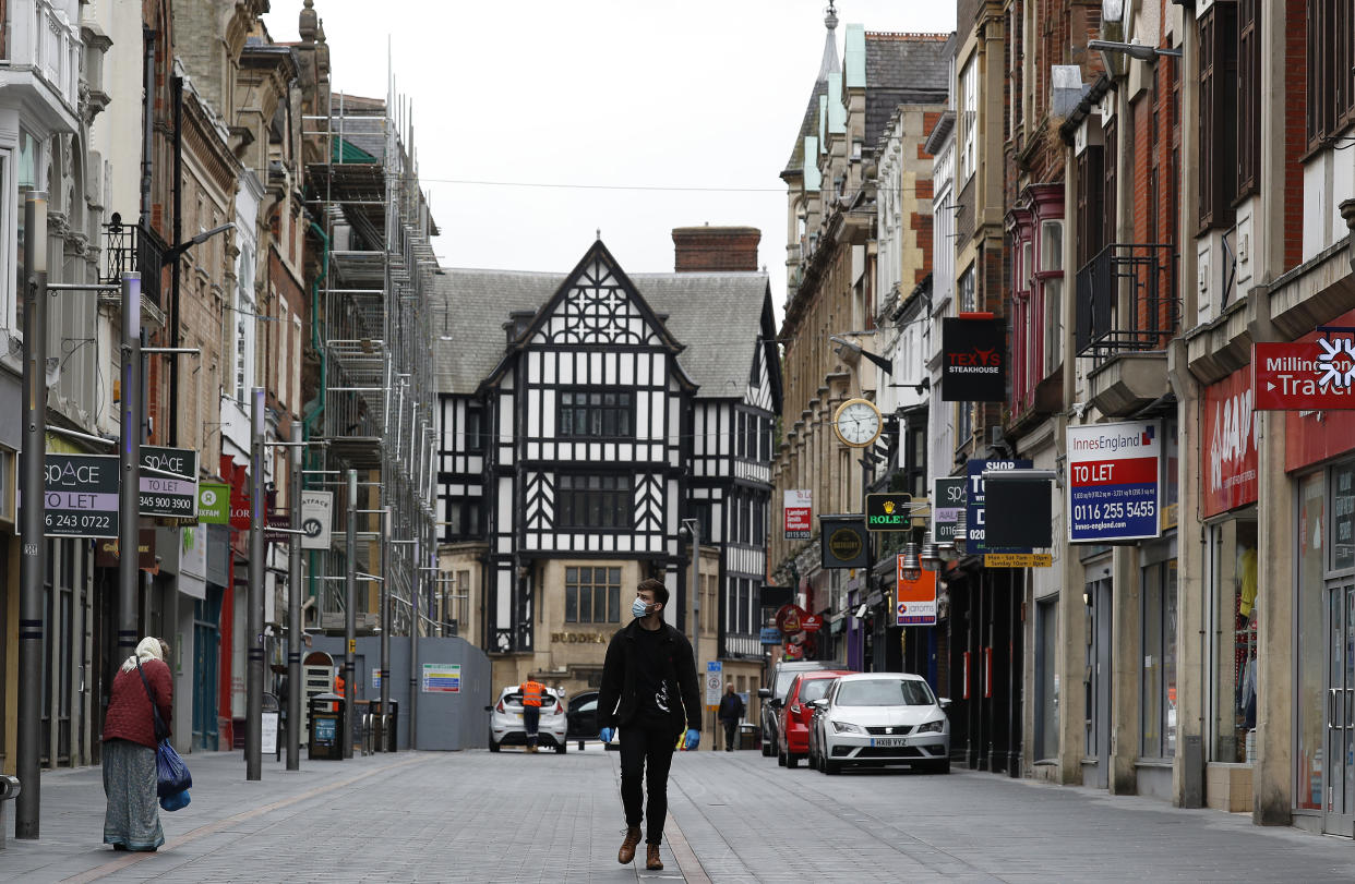 LEICESTER, ENGLAND - JULY 01: A man walks down a near empty shopping street during lockdown on July 01, 2020 in Leicester, England. Ten per cent of all the recent UKs Covid-19 deaths occurred in Leicester, which became the first British city to be put into regional lockdown on Tuesday night. (Photo by Darren Staples/Getty Images)