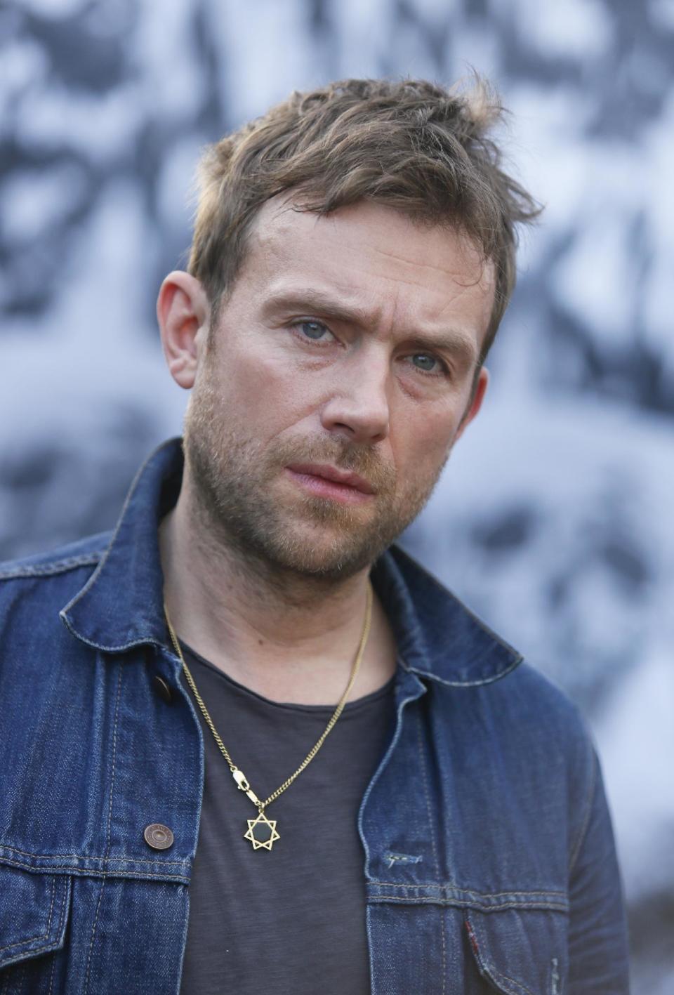 FILE - In this March 14, 2014 file photo, Damon Albarn poses for a photograph during the SXSW Music Festival, in Austin, Texas. Albarn's new album, "Everyday Robots," released on Monday, April 28, 2014. (Photo by Jack Plunkett/Invision/AP, file)