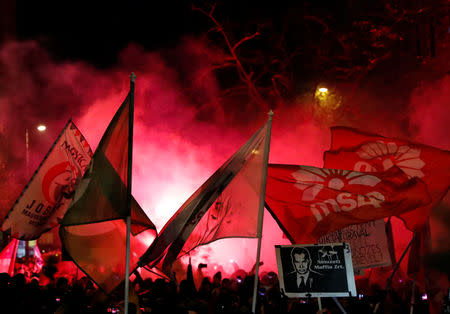 People hold flags as they take part in a protest against a proposed new labor law, billed as the "slave law", in Budapest, Hungary, December 16, 2018. REUTERS/Bernadett Szabo