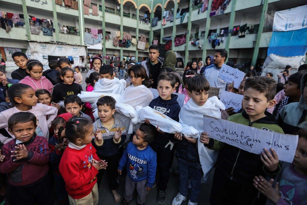 Palestinian children march during a protest demanding an end to the Gaza war on Feb. 14, 2024, in Rafah.