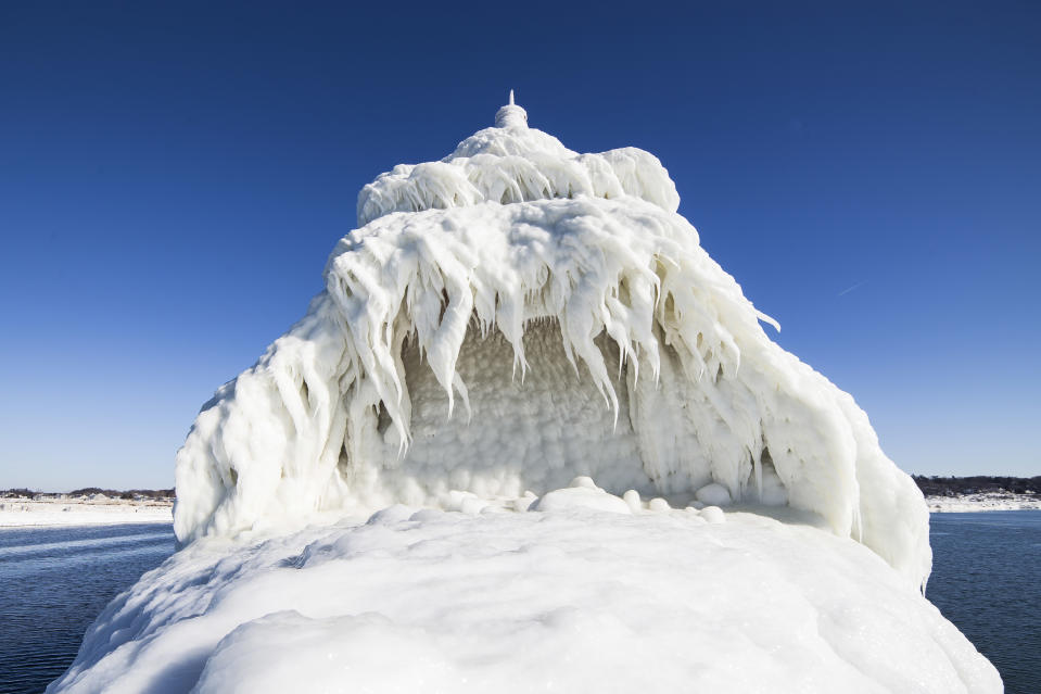 SOUTH HAVEN, MI - JANUARY 8: Ice build-up on the top of the front of the Grand Haven South Pier Entrance Light, on January 8, 2015, in South Haven, Michigan.ICE engulfs a red lighthouse as a fierce winter storm grips South Haven, Michigan. Sharp icicles and surreal formations can be seen hanging from the railings after strong waves crashed onto the piers. After each coating the water quickly freezes to ice and the pier is transformed into a slippery, white wonderland. Weather in the area dipped into the minus figures and froze over Lake Michigan in the beginning of January.PHOTOGRAPH BY Mike Kline / Barcroft MediaUK Office, London.T +44 845 370 2233W www.barcroftmedia.comUSA Office, New York City.T +1 212 796 2458W www.barcroftusa.comIndian Office, Delhi.T +91 11 4053 2429W www.barcroftindia.com