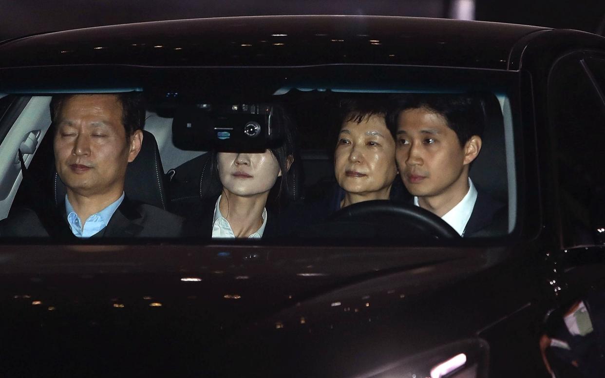 Ousted South Korean president Park Geun-hye (second right), leaves the prosecutors' office as she is transferred to a detention house in Seoul - GETTY IMAGES POOL