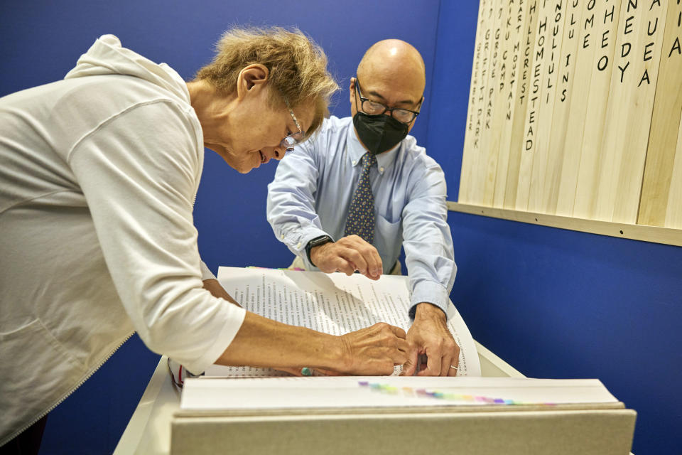 Sharon Yukiye Wu stamps a blue seal in the Ireichō. (Yuri Hasegawa at NBC News)