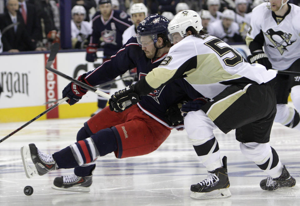 Pittsburgh Penguins' Kris Letang, right, knocks Columbus Blue Jackets' Boone Jenner off of the puck during the second period of Game 6 of a first-round NHL playoff hockey series Monday, April 28, 2014, in Columbus, Ohio. (AP Photo/Jay LaPrete)