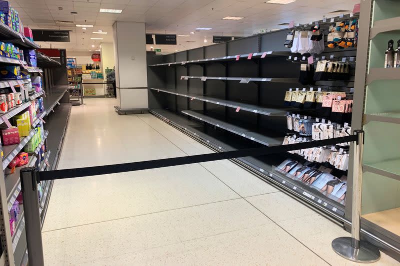 Empty shelves are seen at a supermarket in Canary Wharf in London