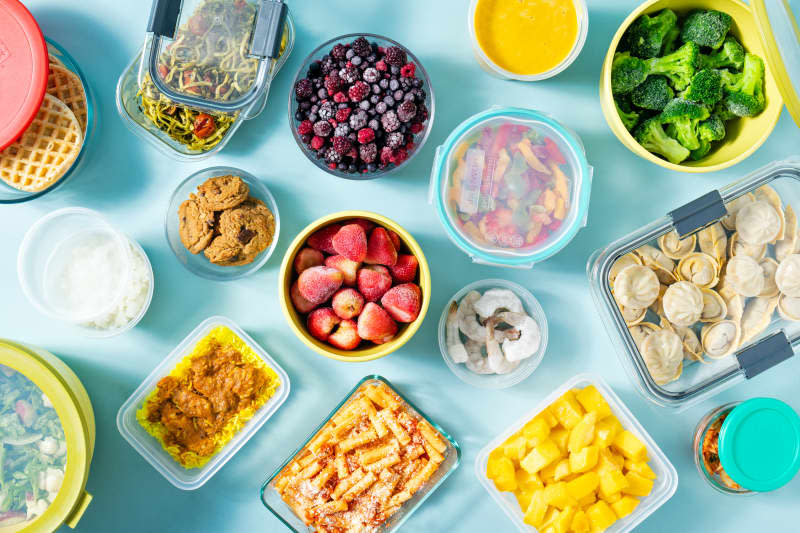 Overhead of different food storage containers filled with frozen food