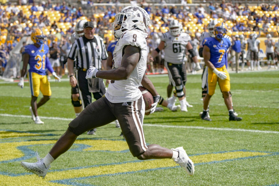 Western Michigan running back Sean Tyler (9) dashes through the end zone after scoring a touchdown against the Pittsburgh defense during the first half of an NCAA college football game, Saturday, Sept. 18, 2021, in Pittsburgh. (AP Photo/Keith Srakocic)