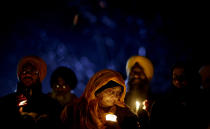 <p>Surjit Kaur Gill, of Worcester, Mass., joins a group of Sikhs from around the Northeastern U.S., in a moment of prayer as a memorial service is broadcast over a loudspeaker outside Newtown High School for the victims of the Sandy Hook Elementary School shooting, Dec. 16, 2012, in Newtown, Conn. (AP Photo/David Goldman) </p>