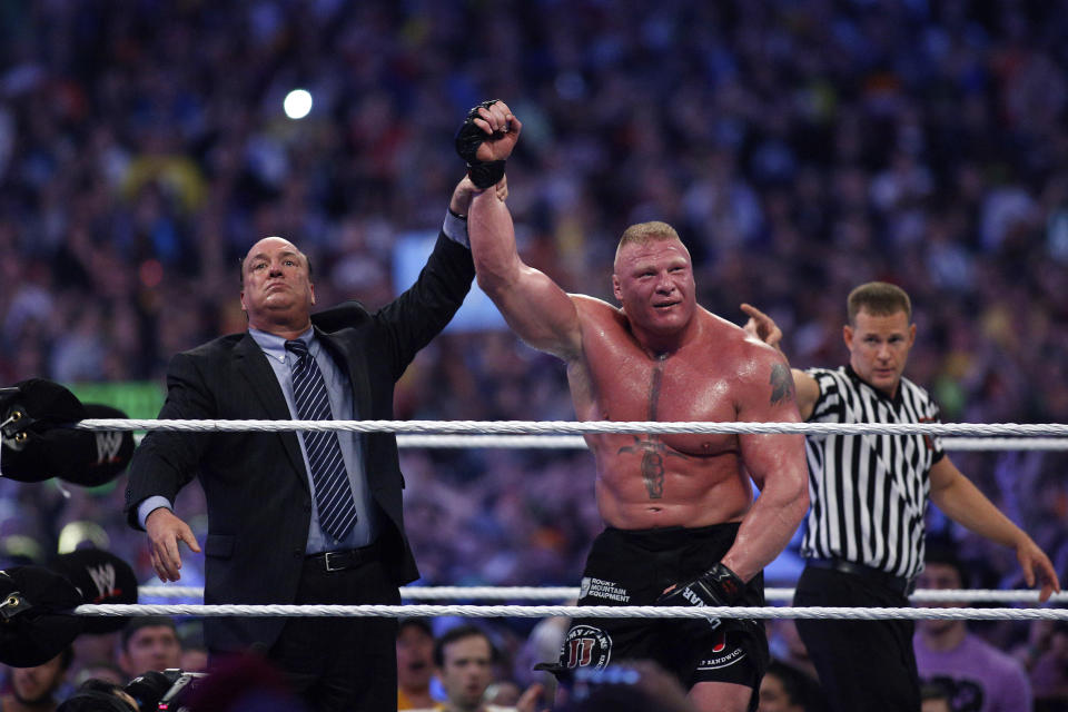 FILE - Paul Heyman, left, celebrates with Brock Lesnar after his win over the Undertaker during Wrestlemania XXX at the Mercedes-Benz Super Dome in New Orleans on Sunday, April 6, 2014. Heyman will be inducted into the WWE Hall of Fame during a ceremony at the Wells Fargo Center in Philadelphia on April 5. (Jonathan Bachman/AP Images for WWE, File)