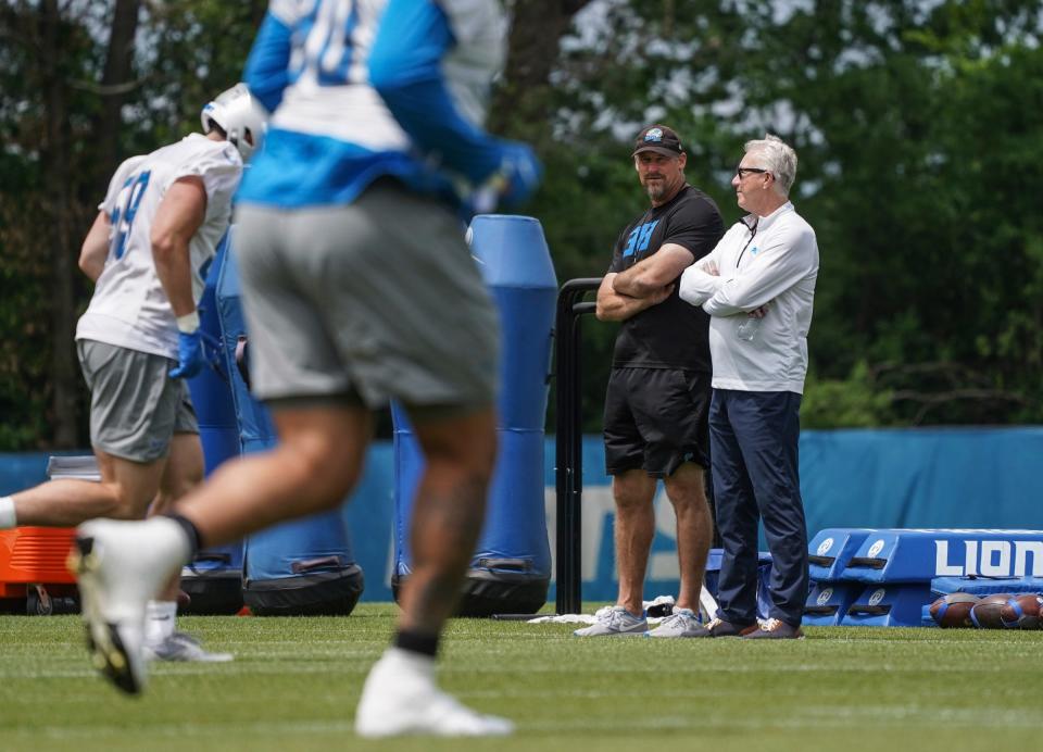 Lions coach Dan Campbell talks with team president Rod Wood, right, during a practice at the Lions practice facility in Allen Park on Monday, June 12, 2023.