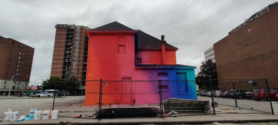 841 Ouellette Avenue in Windsor is shown in the midst of being spray-painted rainbow colours.