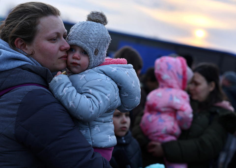 Ukrainian women who were fleeing Russian invasion of Ukraine hold their children as they arrive at a temporary camp in Przemysl, Poland, March 1, 2022.   REUTERS/Kai Pfaffenbach